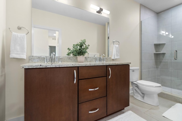410 N First St Unit 207, Ann Arbor, MI 48103 - full bath featuring double vanity, toilet, tiled shower, and tile patterned flooring