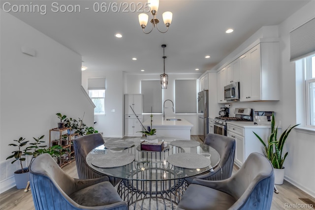 137 Monument Ln, Wixom, MI 48393 - dining area with plenty of natural light, recessed lighting, light wood-style floors, and a chandelier