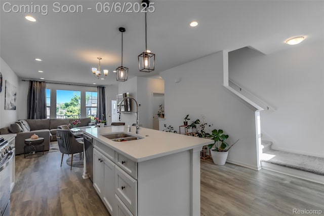 137 Monument Ln, Wixom, MI 48393 - kitchen with a sink, wood finished floors, open floor plan, dishwasher, and recessed lighting