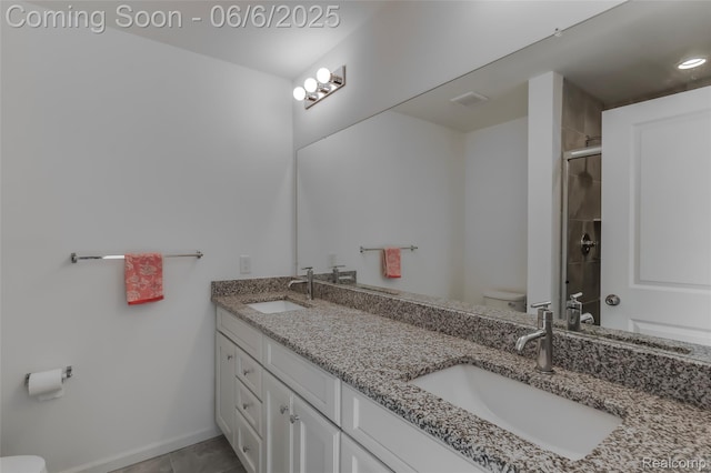 137 Monument Ln, Wixom, MI 48393 - full bath featuring toilet, double vanity, an enclosed shower, and tile patterned floors