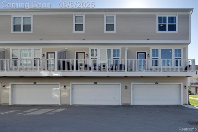 137 Monument Ln, Wixom, MI 48393 - rear view of house featuring an attached garage