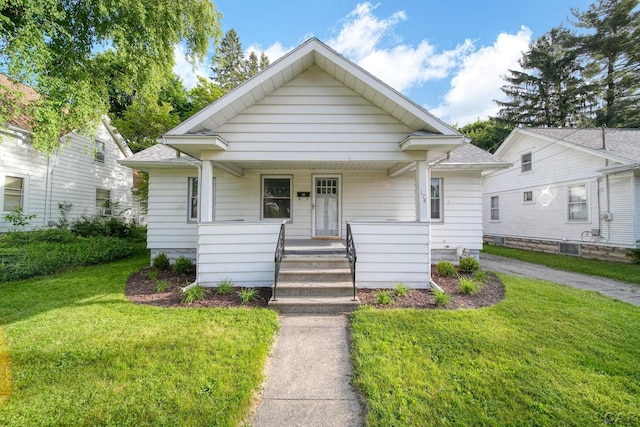 174 W Mansion St, Jackson, MI 49203 - bungalow-style house featuring covered porch, a front yard, and a shingled roof