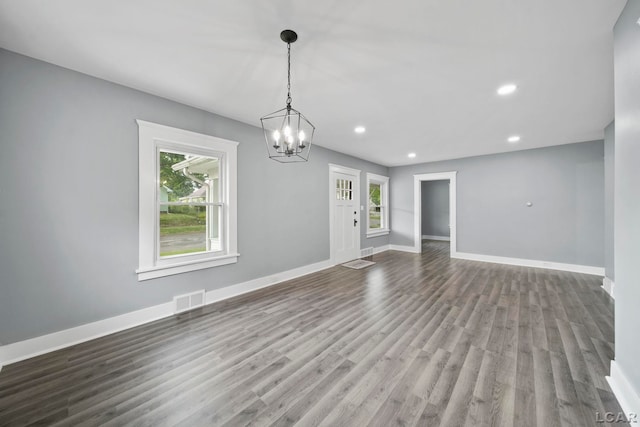 174 W Mansion St, Jackson, MI 49203 - unfurnished living room with wood finished floors, baseboards, a chandelier, and recessed lighting