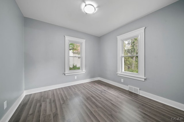174 W Mansion St, Jackson, MI 49203 - empty room featuring dark wood-style floors and baseboards