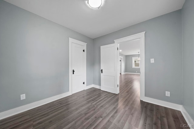 174 W Mansion St, Jackson, MI 49203 - spare room with baseboards and dark wood-style floors
