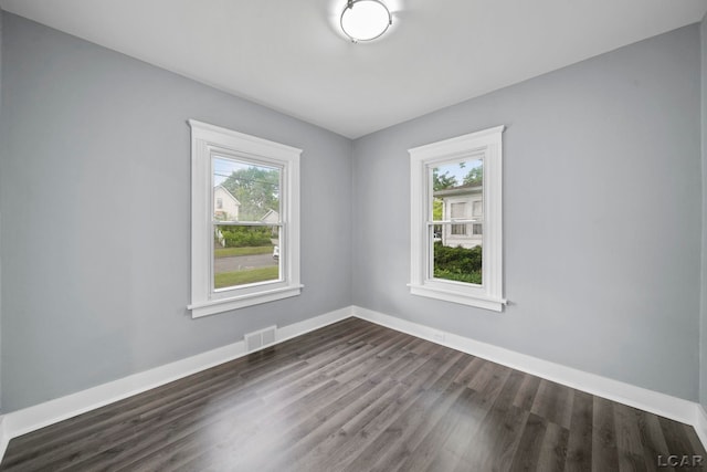 174 W Mansion St, Jackson, MI 49203 - spare room with dark wood-type flooring and baseboards