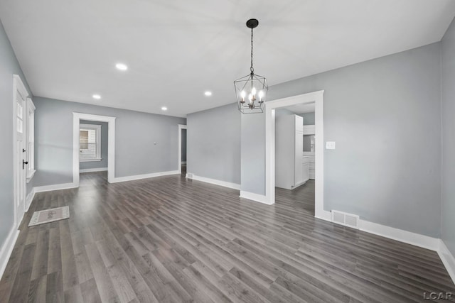 174 W Mansion St, Jackson, MI 49203 - unfurnished living room featuring a chandelier, dark wood-style flooring, recessed lighting, and baseboards