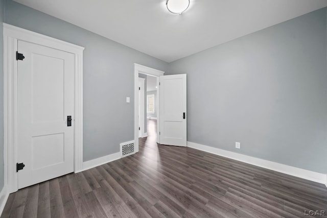 174 W Mansion St, Jackson, MI 49203 - unfurnished bedroom featuring wood finished floors and baseboards