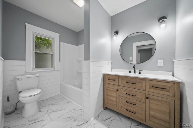 174 W Mansion St, Jackson, MI 49203 - bathroom featuring marble finish flooring, vanity, toilet, a wainscoted wall, and bathing tub / shower combination