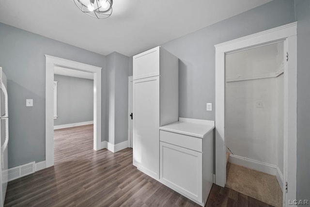 174 W Mansion St, Jackson, MI 49203 - hall with dark wood-type flooring and baseboards