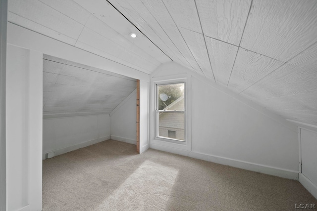 174 W Mansion St, Jackson, MI 49203 - bonus room with vaulted ceiling, carpet floors, and baseboards