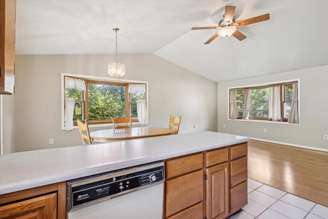 502 Woodland Dr, Buchanan, MI 49107 - kitchen featuring dishwasher, light countertops, a chandelier, brown cabinetry, and vaulted ceiling