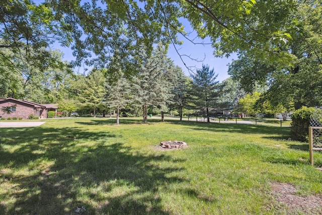 502 Woodland Dr, Buchanan, MI 49107 - view of grassy yard featuring an outdoor fire pit