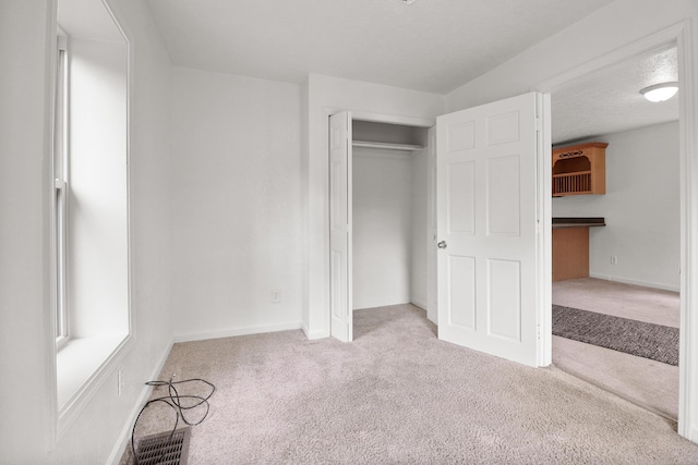 238 Long Ave, Michigan Center, MI 49254 - unfurnished bedroom with carpet floors, baseboards, and a closet