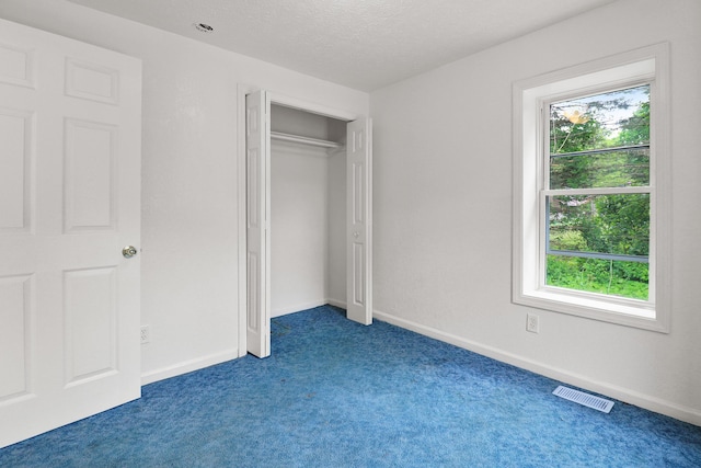 238 Long Ave, Michigan Center, MI 49254 - unfurnished bedroom with carpet floors, baseboards, a textured ceiling, and a closet