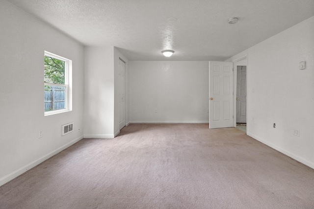 238 Long Ave, Michigan Center, MI 49254 - spare room featuring light carpet, a textured ceiling, baseboards, and a smoke detector