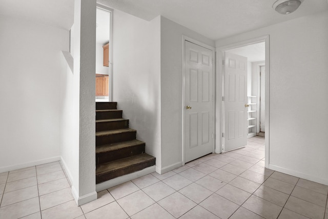 238 Long Ave, Michigan Center, MI 49254 - staircase featuring tile patterned flooring and baseboards