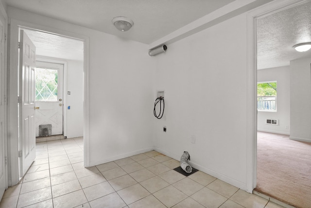 238 Long Ave, Michigan Center, MI 49254 - washroom featuring hookup for a washing machine, a textured ceiling, healthy amount of natural light, electric dryer hookup, and light tile patterned flooring