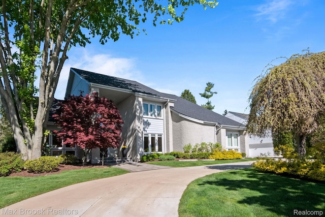 6566 Bristol Dr, West Bloomfield, MI 48322 - view of front facade featuring a front yard, curved driveway, and french doors