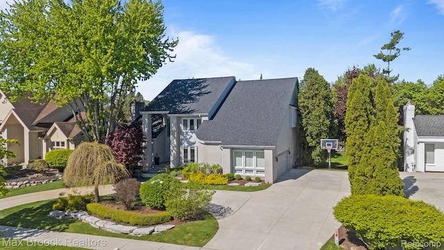 6566 Bristol Dr, West Bloomfield, MI 48322 - view of front of house with concrete driveway, a shingled roof, and stucco siding