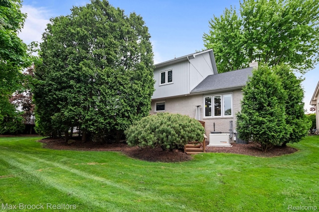 6566 Bristol Dr, West Bloomfield, MI 48322 - back of property with brick siding and a lawn