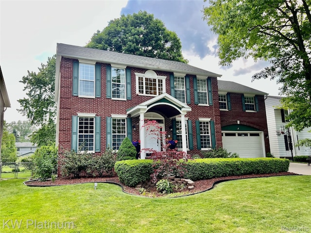 3105 E Woodland Dr, Port Huron, MI 48060 - colonial house with a garage, brick siding, and driveway