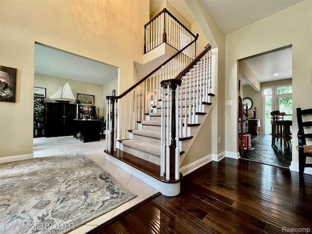 3105 E Woodland Dr, Port Huron, MI 48060 - stairway with hardwood / wood-style flooring and a towering ceiling
