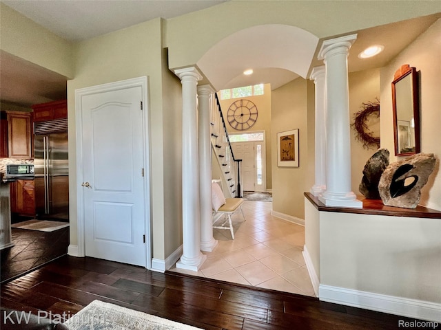 3105 E Woodland Dr, Port Huron, MI 48060 - entrance foyer featuring decorative columns, hardwood / wood-style flooring, arched walkways, and stairway
