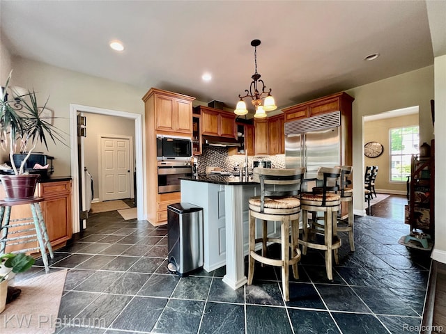 3105 E Woodland Dr, Port Huron, MI 48060 - kitchen featuring built in appliances, dark countertops, a chandelier, decorative backsplash, and recessed lighting