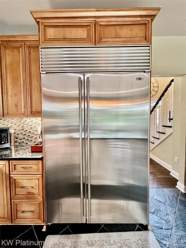 3105 E Woodland Dr, Port Huron, MI 48060 - kitchen with built in refrigerator, brown cabinetry, and decorative backsplash