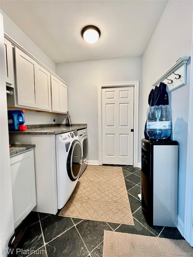 3105 E Woodland Dr, Port Huron, MI 48060 - laundry area with washing machine and dryer, dark tile patterned flooring, and cabinet space