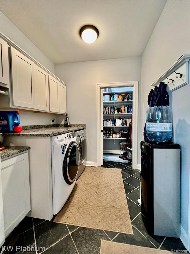 3105 E Woodland Dr, Port Huron, MI 48060 - laundry room with washing machine and clothes dryer, dark tile patterned flooring, and cabinet space