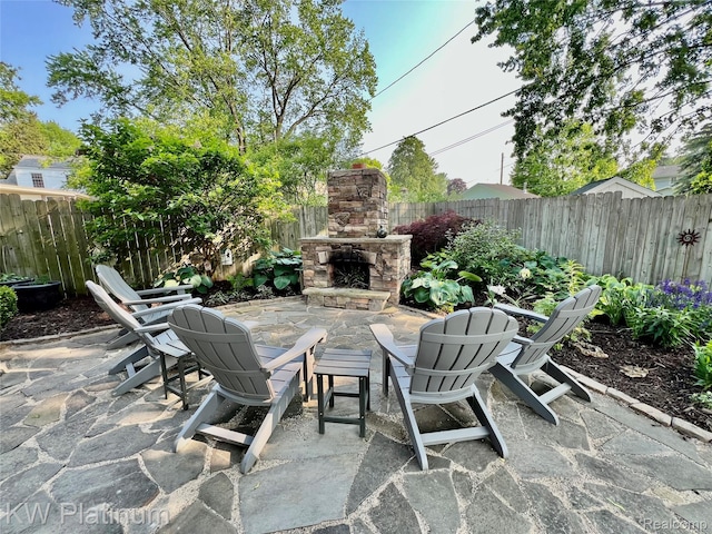 3105 E Woodland Dr, Port Huron, MI 48060 - fenced backyard featuring an outdoor stone fireplace and a patio
