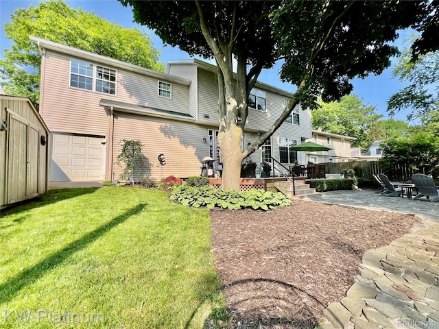 3105 E Woodland Dr, Port Huron, MI 48060 - rear view of house featuring an attached garage and a patio