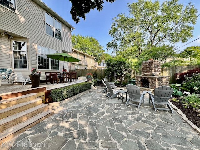 3105 E Woodland Dr, Port Huron, MI 48060 - view of patio featuring an outdoor stone fireplace, outdoor dining area, and a wooden deck
