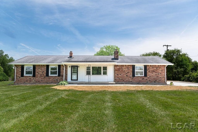 1443 N Posey Lake Rd, Hudson, MI 49247 - ranch-style home with a front yard, a chimney, brick siding, and board and batten siding