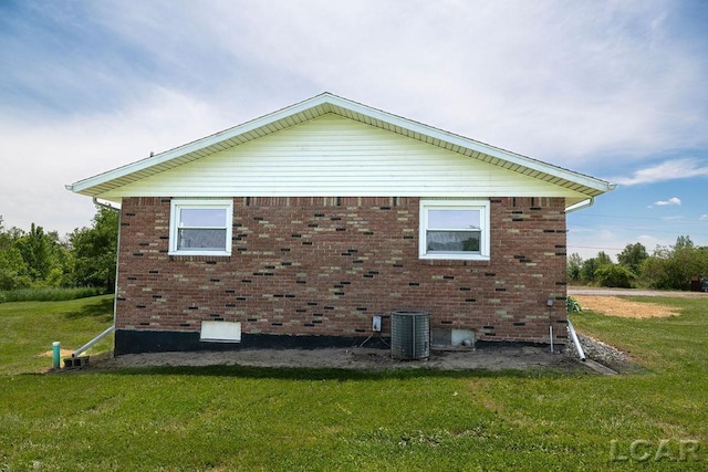 1443 N Posey Lake Rd, Hudson, MI 49247 - view of side of home with a lawn, crawl space, and brick siding