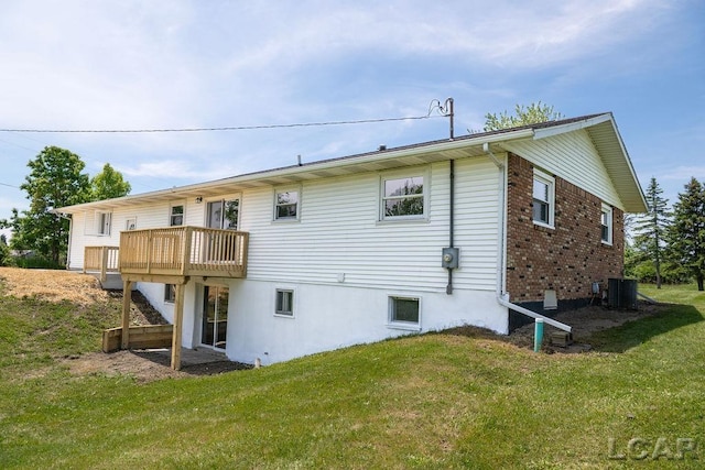 1443 N Posey Lake Rd, Hudson, MI 49247 - rear view of house with central air condition unit, a yard, a wooden deck, and brick siding