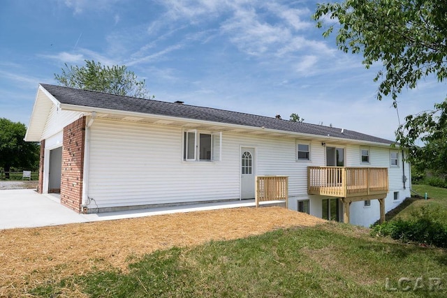 1443 N Posey Lake Rd, Hudson, MI 49247 - back of property with a garage, brick siding, and driveway