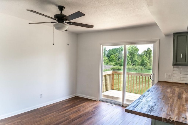 1443 N Posey Lake Rd, Hudson, MI 49247 - spare room with wood finished floors, ceiling fan, baseboards, and a textured ceiling