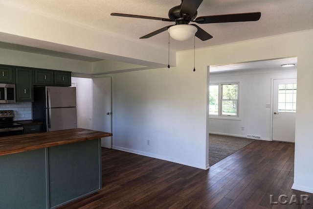 1443 N Posey Lake Rd, Hudson, MI 49247 - kitchen featuring appliances with stainless steel finishes, butcher block counters, ceiling fan, dark wood finished floors, and backsplash