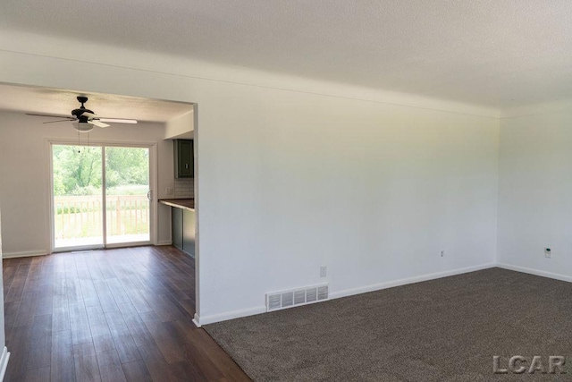 1443 N Posey Lake Rd, Hudson, MI 49247 - unfurnished room with a ceiling fan, dark wood-style floors, and baseboards