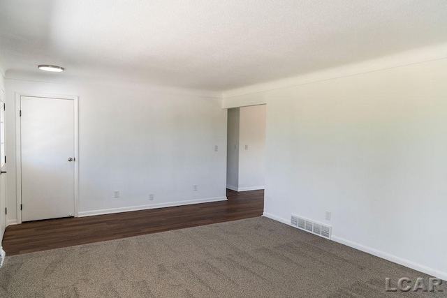 1443 N Posey Lake Rd, Hudson, MI 49247 - unfurnished room with carpet floors, baseboards, and wood finished floors