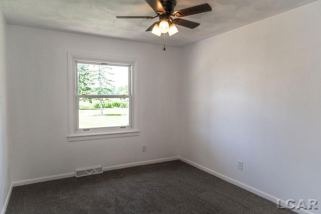 1443 N Posey Lake Rd, Hudson, MI 49247 - empty room featuring a ceiling fan, baseboards, and dark carpet