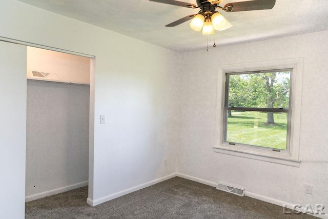 1443 N Posey Lake Rd, Hudson, MI 49247 - unfurnished bedroom with dark colored carpet, baseboards, a closet, and ceiling fan