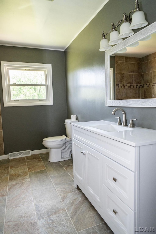 1443 N Posey Lake Rd, Hudson, MI 49247 - bathroom featuring vanity, toilet, and crown molding