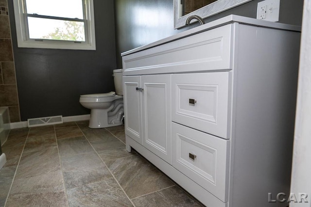 1443 N Posey Lake Rd, Hudson, MI 49247 - full bathroom with toilet, vanity, and baseboards