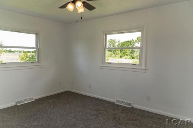 1443 N Posey Lake Rd, Hudson, MI 49247 - empty room featuring dark carpet, baseboards, and ceiling fan