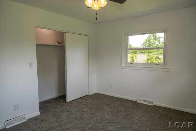 1443 N Posey Lake Rd, Hudson, MI 49247 - unfurnished bedroom with dark carpet, a closet, and baseboards