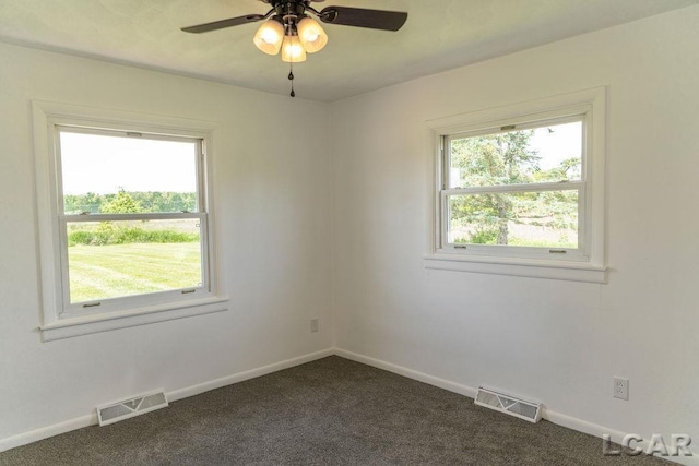 1443 N Posey Lake Rd, Hudson, MI 49247 - spare room featuring dark carpet, baseboards, and a ceiling fan